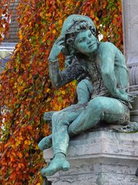 Statue of angel during autumn