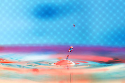 Close-up of water droplet against abstract background