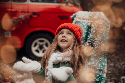 Portrait of smiling young woman in car