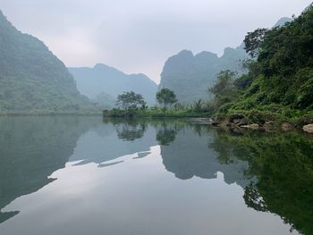 Scenic view of lake and mountains against sky