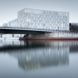 Reflection of bridge on water in city