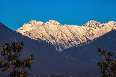 Scenic view of mountains against clear blue sky