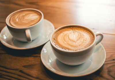 High angle view of coffee cups on table