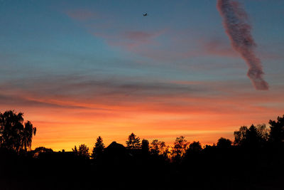 Low angle view of silhouette trees against sky at sunset