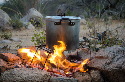 Close-up of saucepan on bonfire in african bush