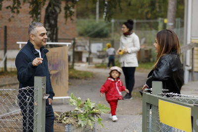 Man and woman talking at gate