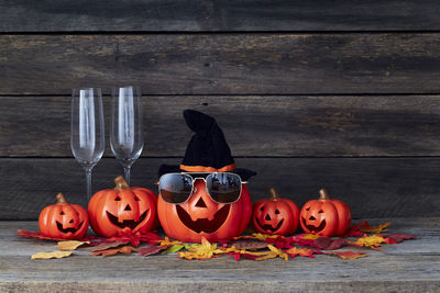 High angle view of pumpkins on table against wall during halloween