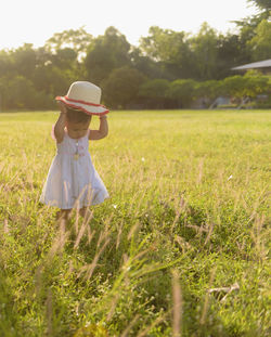 Asian baby girl walking in the meadow with copy space happy family day concept. silhouette.