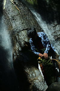 High angle view of man holding rock