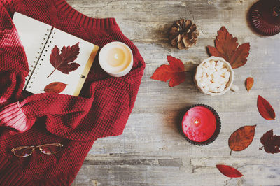 High angle view of coffee with red sweater on illuminated table