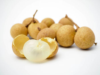 Close-up of fruits in plate against white background