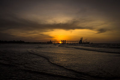 Scenic view of beach against dramatic sky