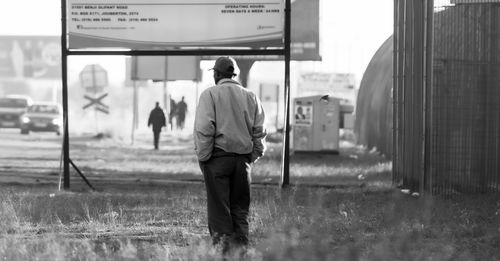 Rear view of man standing on field