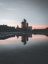 Reflection of buildings in lake against sky