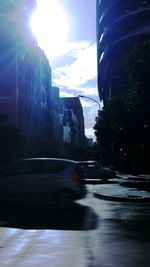 Cars on road against cloudy sky