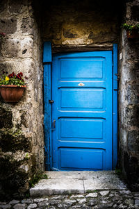 Closed blue door of old building