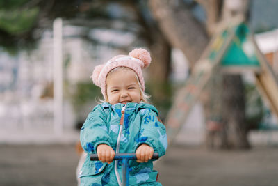 Portrait of cute baby girl standing outdoors