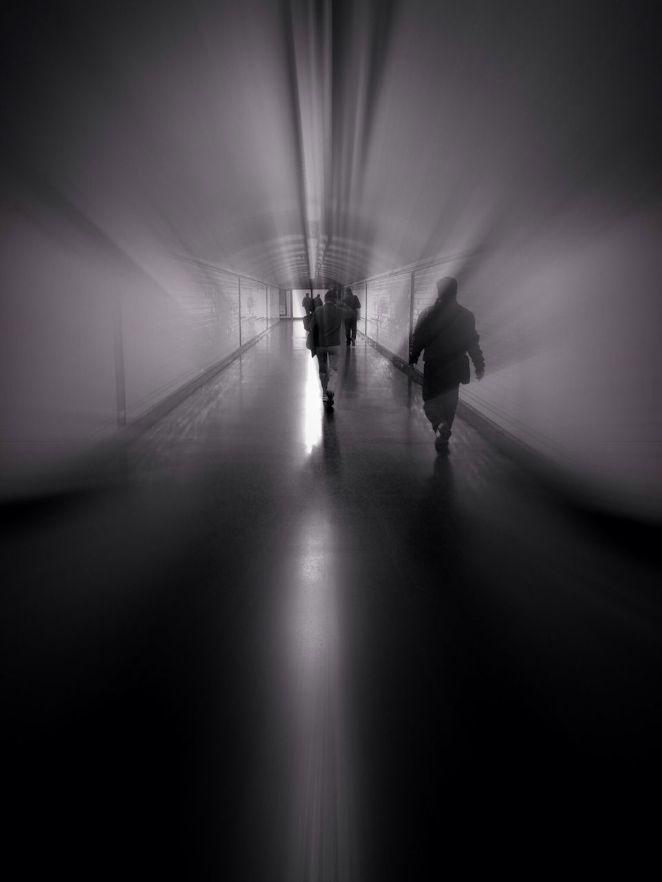 transportation, indoors, walking, men, lifestyles, tunnel, the way forward, rear view, full length, on the move, illuminated, silhouette, leisure activity, person, mode of transport, unrecognizable person, travel, diminishing perspective