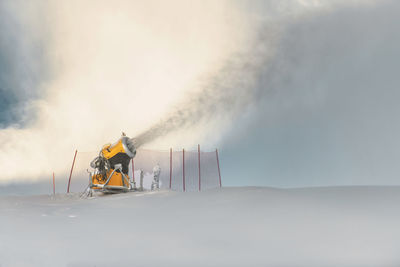 A snow cannon in action at a ski resort