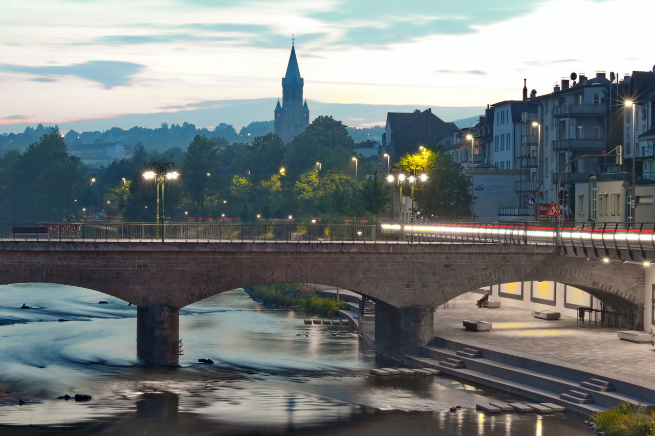 BRIDGE OVER RIVER IN CITY AGAINST SKY