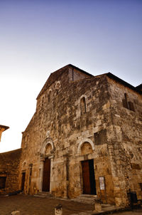 Low angle view of old building against clear sky