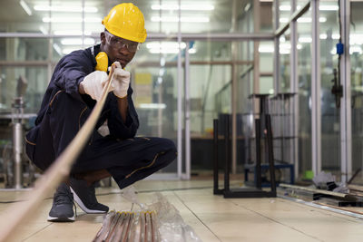 Full length of worker working in factory