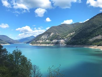 Scenic view of lake and mountains against sky