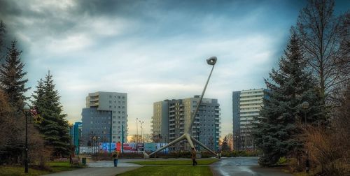 Modern buildings against cloudy sky