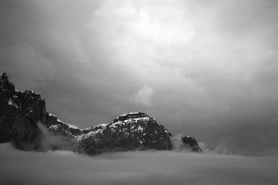 Low angle view of snowcapped mountain against sky