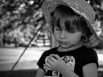 Close-up of cute girl looking at her hand