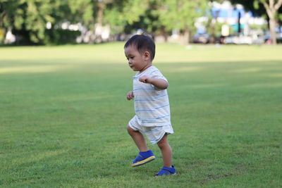 Cute boy standing on field