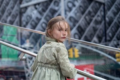 Girl standing on railing at time square new york