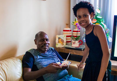 Portrait of a smiling young woman holding food