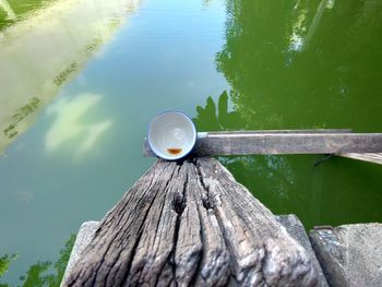 High angle view of wooden post on pier at lake