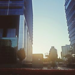 Cityscape against clear sky during sunset