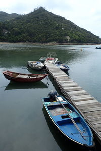 Boat moored in lake against sky