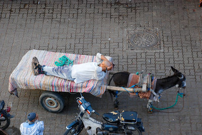 High angle view of man sleeping on street