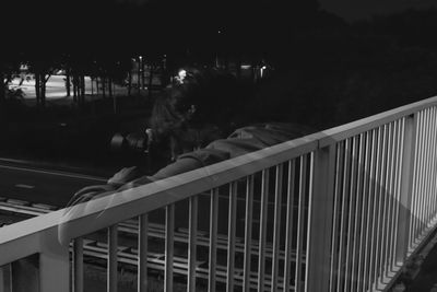 People on illuminated railing
