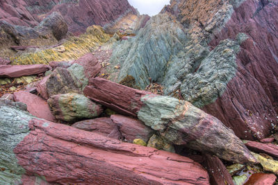 Colorful geologic rock formations on sea shore