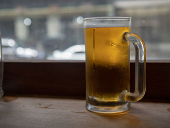 Close-up of beer glass on table