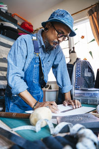 Man working over fabric on table