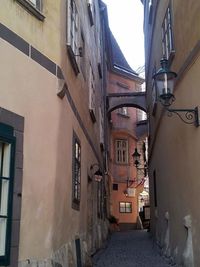 Alley amidst buildings against sky