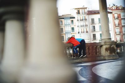 Man with red umbrella in city