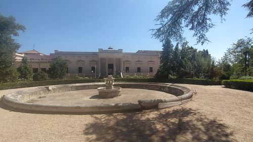 Fountain in garden against sky