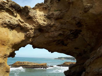 Scenic view of sea seen through cave