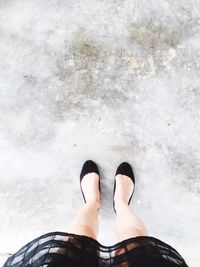 Low section of woman standing on concrete