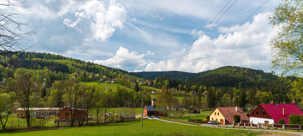 Panoramic shot of trees and houses against sky