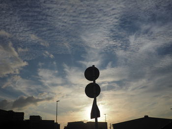 Low angle view of silhouette buildings against sky