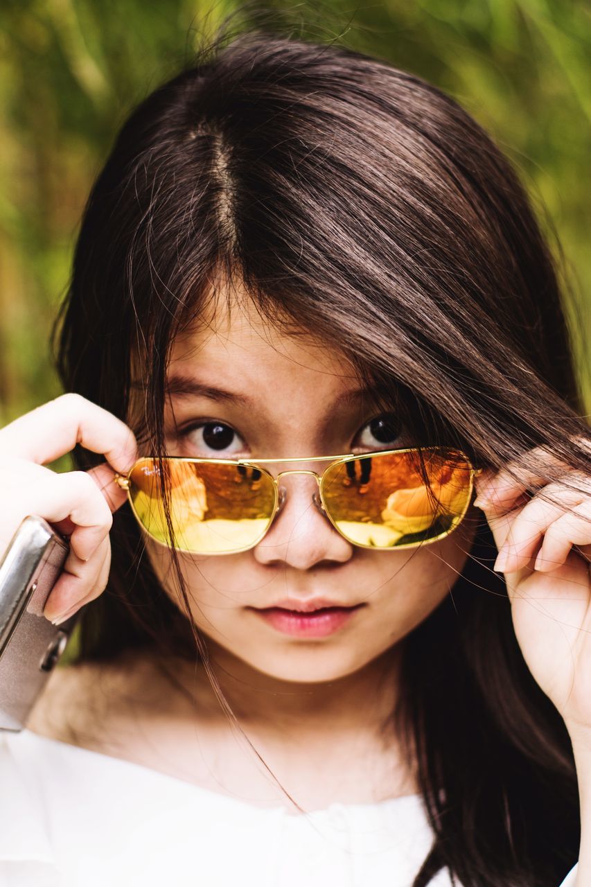 looking at camera, portrait, real people, one person, front view, lifestyles, leisure activity, headshot, focus on foreground, childhood, young women, young adult, beautiful woman, smiling, day, close-up, outdoors