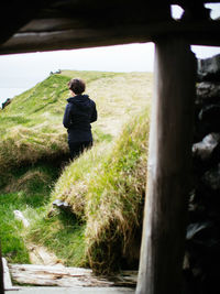 Rear view of man walking on landscape